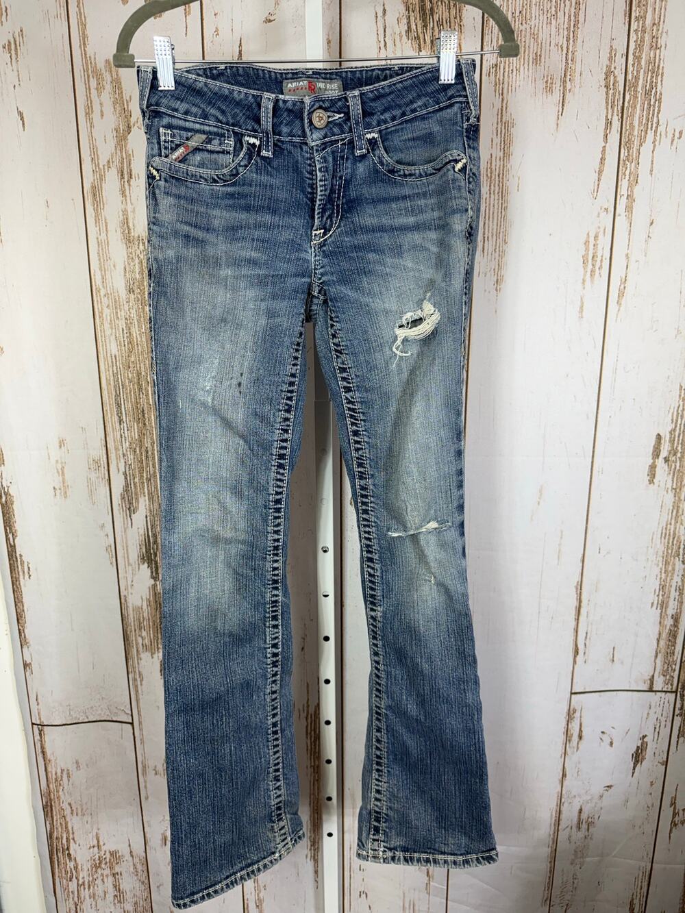 Ariat, FR Mid Rise Boot Cut Jeans. Size 26R. Fair Condition! Holes as pictured.